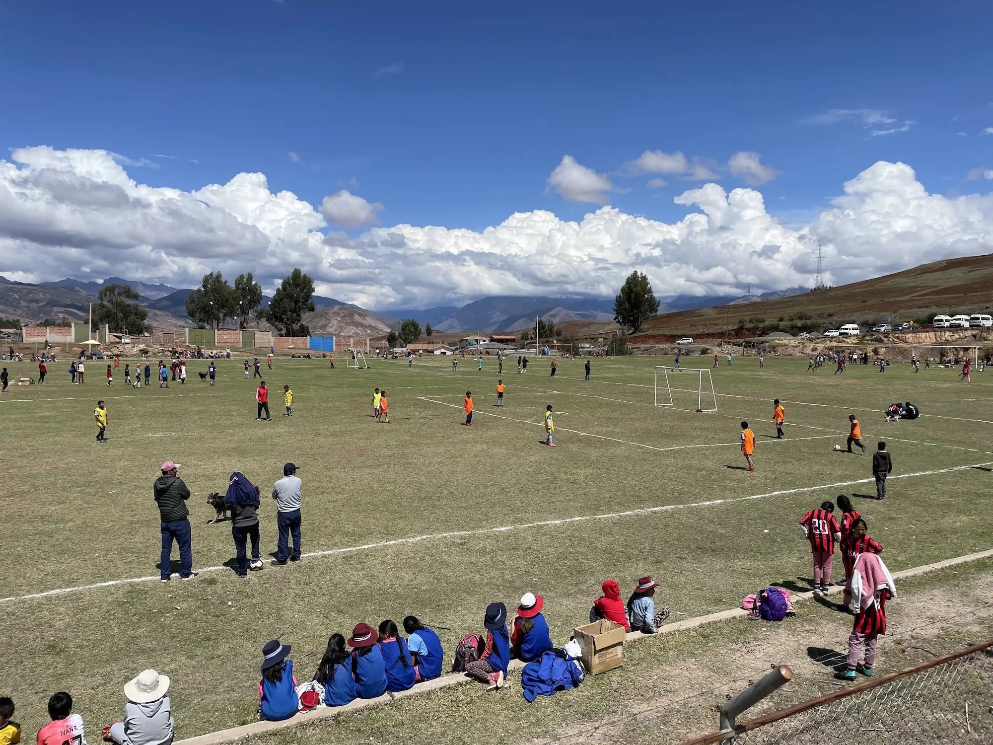 Children playing soccer on a highland pitch in Peru - Sinkumunchis community program supported by STMNT Wear